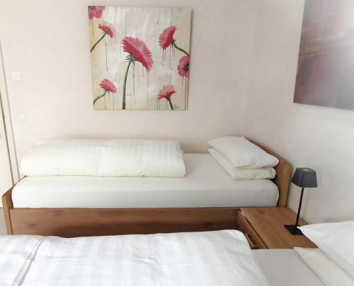 a room with two beds and a painting on the wall at Bed and Breakfast am Höhenweg in Warstein