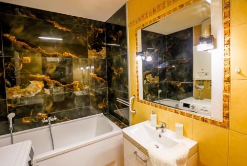 a bathroom with a tub and a sink and a bath tub at Balaton Vista in Balatonfüred