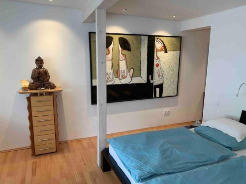a bedroom with a bed and a painting on the wall at Wohnhaus am Marktplatz in Röhrnbach in Röhrnbach