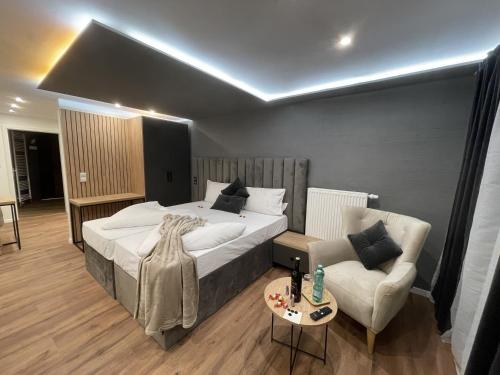 a bedroom with a large bed and a couch at Apartmenthaus Zeuthen 3 in Zeuthen