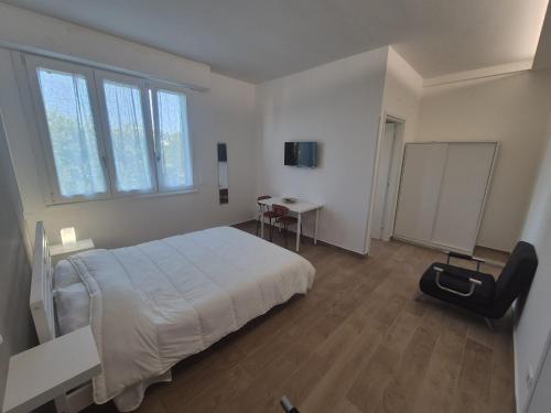 a bedroom with a bed and a desk and a tv at Affittacamere Le Fontane in Altopascio