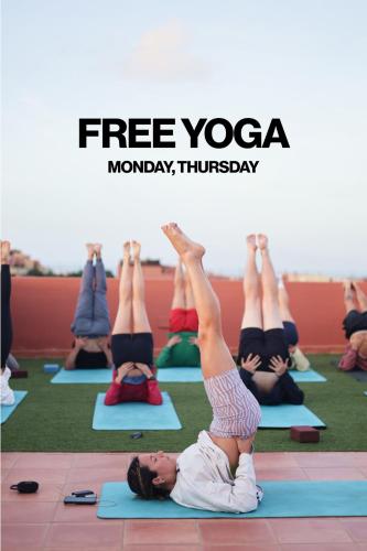 a group of people in a yoga class at Banama Surfhouse - Coliving Coworking & Yoga in Corralejo