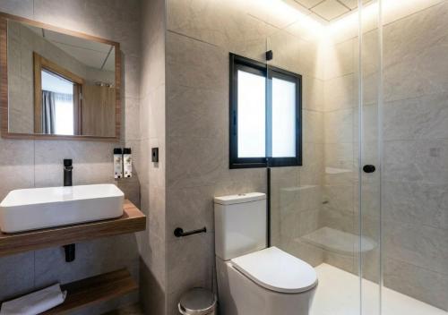 a bathroom with a toilet and a sink and a shower at Nommadas Cotty - Only Adults in Denia