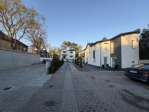 a cobblestone street with houses and a car on it at Apartmenthaus Zeuthen 2 in Zeuthen