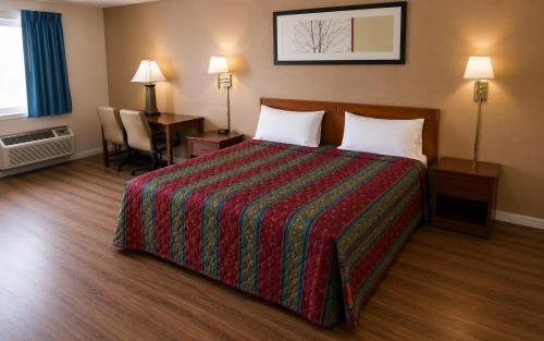 a hotel room with a bed and a desk at Segovia Lodge Junction TX I -10 in Junction