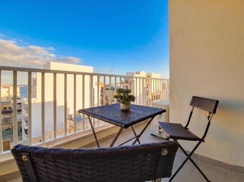 a table and chairs on a balcony with a view at Merhba Court Apartments - St Pauls Bay in St. Paul's Bay