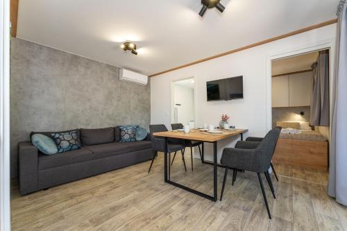 a living room with a table and a couch at Casa Mare Drage in Drage