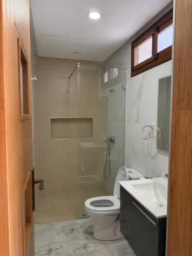 a bathroom with a shower and a toilet and a sink at Armonia buglaow residence MARSA MDIQ in M'diq