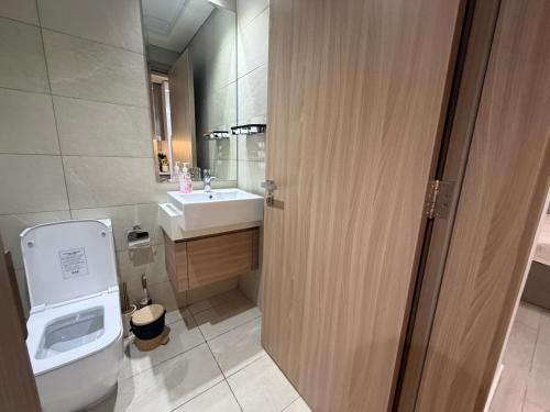 a bathroom with a toilet and a sink at Azizi Riviera in Dubai