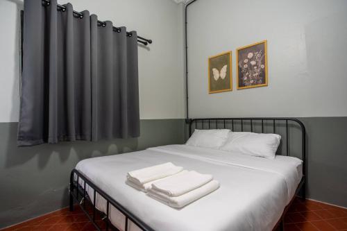 a bedroom with a bed with two towels on it at Judy house Betong in Betong