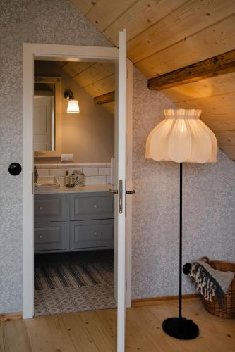 a kitchen with a table and a lamp in a room at Dom Na Biegunach in Cięcina