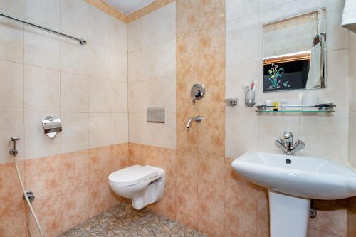 a bathroom with a sink and a toilet and a shower at The Culture Resort in Pokhara