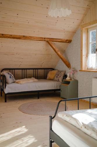 a bedroom with a bed in a wooden room at Dom Na Biegunach in Cięcina