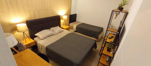 a small bedroom with a bed and a mirror at Sesimbra Sea Apartment with Pool & Gym near Lisbon in Sesimbra