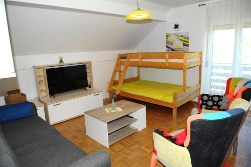 a living room with a couch and a bunk bed at Green Touch in Ivanjkovci