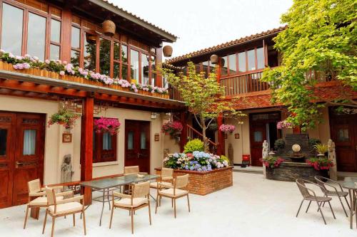 a patio with a table and chairs and a fountain at Jingshan Garden Courtyard Hotel Beijing Forbidden City Newly renovated Tianmen Wangfujing Gardenhutong BejjingCourtyard in Beijing