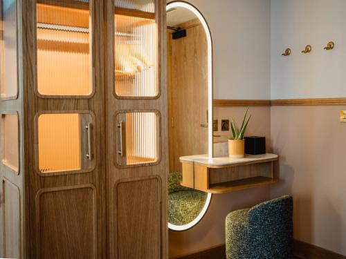 a room with a wooden door and a mirror at Carlton George Hotel in Glasgow