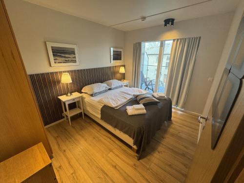 a bedroom with a bed and a window at Downtown Reykjavík Apartments in Reykjavík