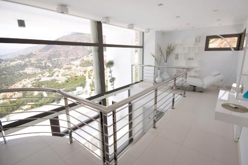a staircase in a white room with a view at Altea Hills Luxury Villas in Altea
