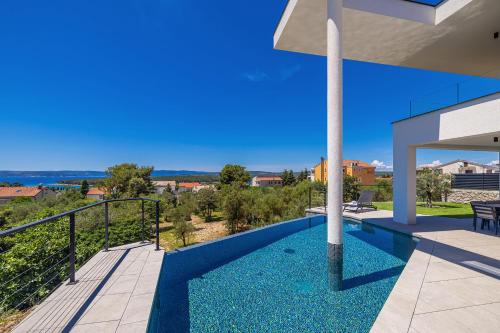 a view of a house with a swimming pool at Luxury villa 45 with infinity pool in Punat
