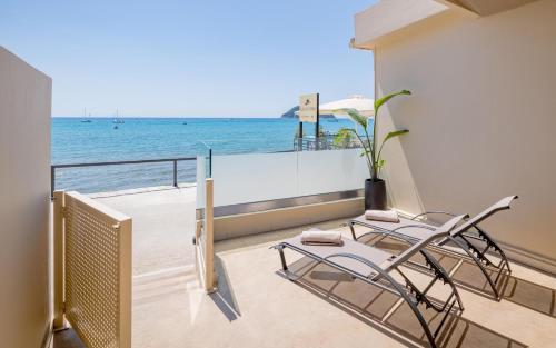 a balcony with chairs and a view of the ocean at Blue Horizon Studios in Laganas
