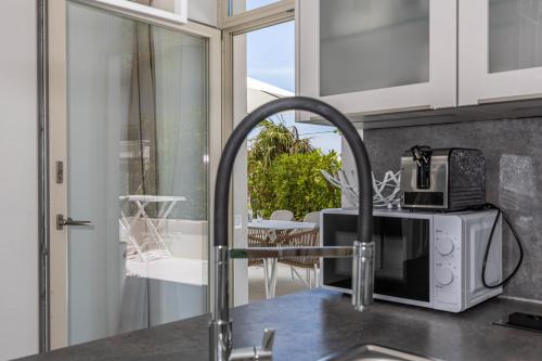 a kitchen with a sink and a microwave at Villa Vita luxury Apartments in Crikvenica