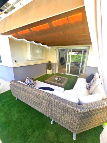 a large wicker couch sitting on the grass at Villa with private pool and jacuzzi - EN10LT in Torre-Pacheco