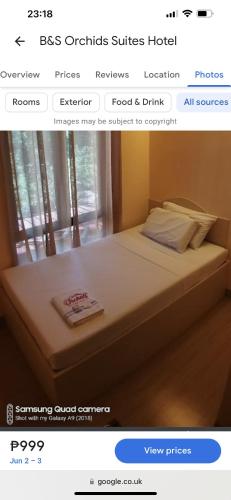 a picture of a bed in a room at B&S Orchids Suites Hotel in Dipolog
