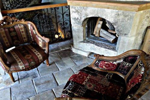 a room with two chairs and a fireplace at Kemerli Konak Boutique Hotel in Kérynia