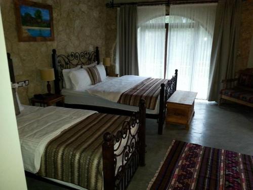 a bedroom with two beds and a window at Kemerli Konak Boutique Hotel in Kérynia