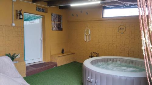 a bathroom with a large tub in a room at Villa las rosas in Agaete