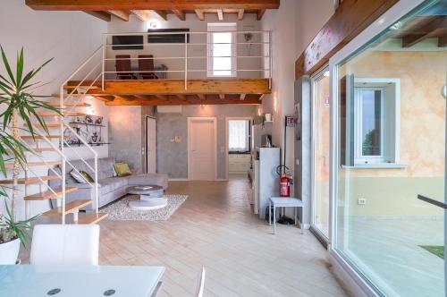 a living room with a staircase in a house at Villa Ulivi Private Pool & Lake View in Montinelle