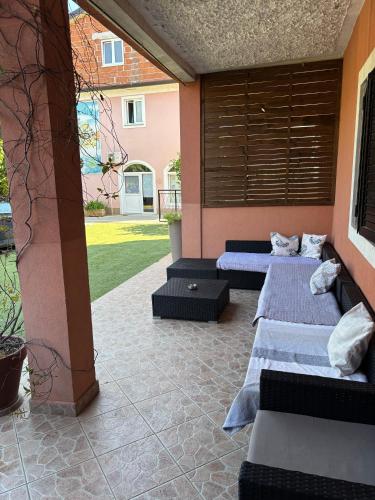 two beds in a room with a courtyard at Apartments Tajana in Novigrad Istria