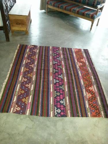 a rug on the floor in a living room with a couch at Kemerli Konak Boutique Hotel in Kérynia