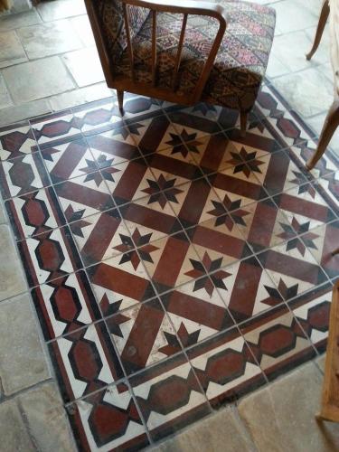 a rug with a chair on a tiled floor at Kemerli Konak Boutique Hotel in Kérynia