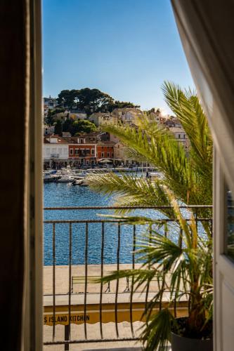 a view of a body of water from a balcony at Hotel Apoksiomen in Mali Lošinj