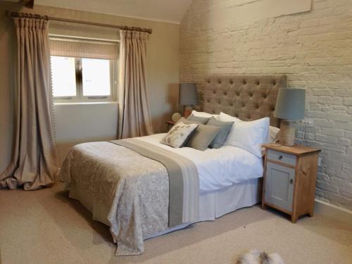 a bedroom with a large bed and a window at Black Drove Farm in Twenty