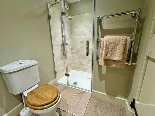 a bathroom with a toilet and a glass shower at Black Drove Farm in Twenty