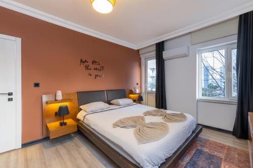 a bedroom with a large bed with white sheets at Melissas Suites Lara in Antalya