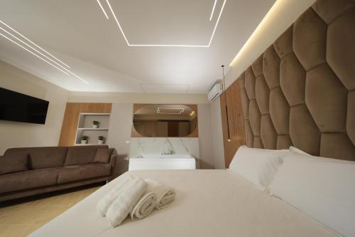 a bedroom with a bed and a couch at Live in Gaeta in Gaeta