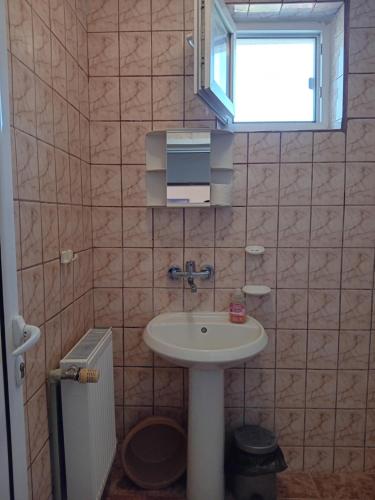a bathroom with a sink and a window at Guest House Sun in Kranevo