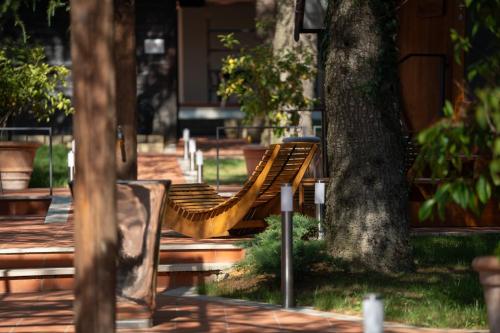 a row of park benches next to a tree at Rifugio diVino Dormire in una botte - Wine Barrel stay near Rome in Rieti