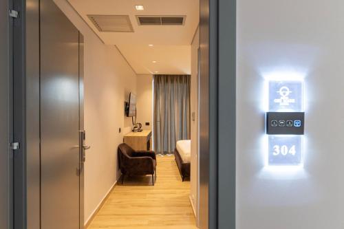 a room with a door and a room with a bedroom at Ori Mare Hotel in Ksamil