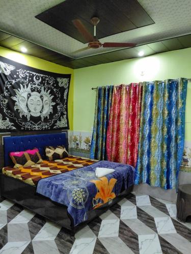 a bedroom with a bed in a room with curtains at The nomadics nest in Bhadarwāh