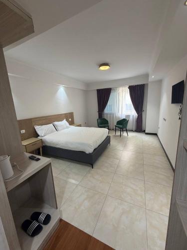 a hotel room with a bed and a desk at Iconic Coworking Hotel in Addis Ababa