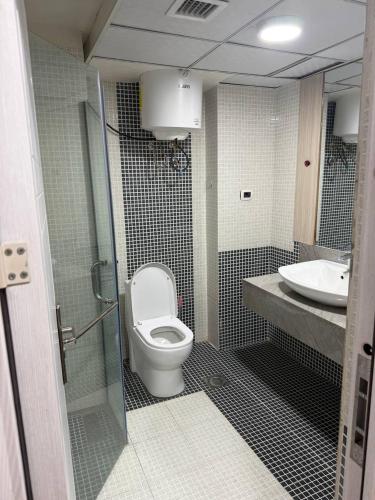 a bathroom with a toilet and a sink at Iconic Coworking Hotel in Addis Ababa