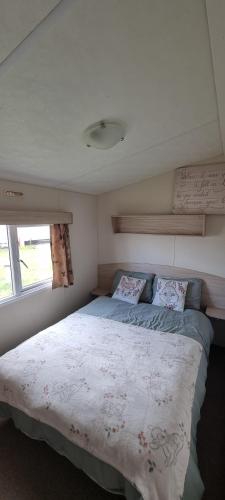 a bedroom with a bed and a window at E21 The Sandy Heaven in Lossiemouth