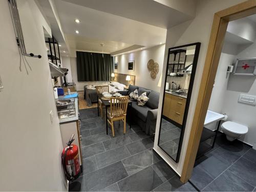 a kitchen and a living room with a couch and a table at Downtown Reykjavík Apartments in Reykjavík