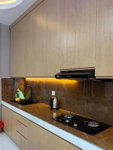 a kitchen with a stove top oven in a kitchen at Milano Villas Puncak in Puncak
