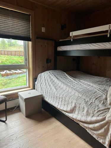 a bedroom with a bunk bed and a window at Harevadet 221 in Volda